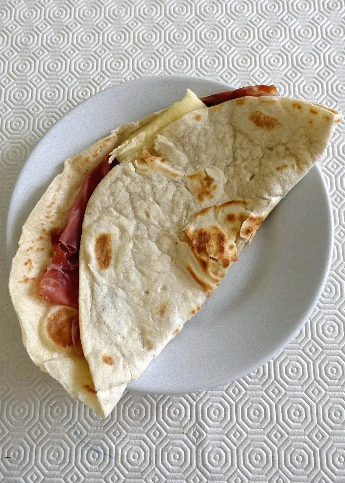 Freshly cooked hot piadina romagnola on the testo