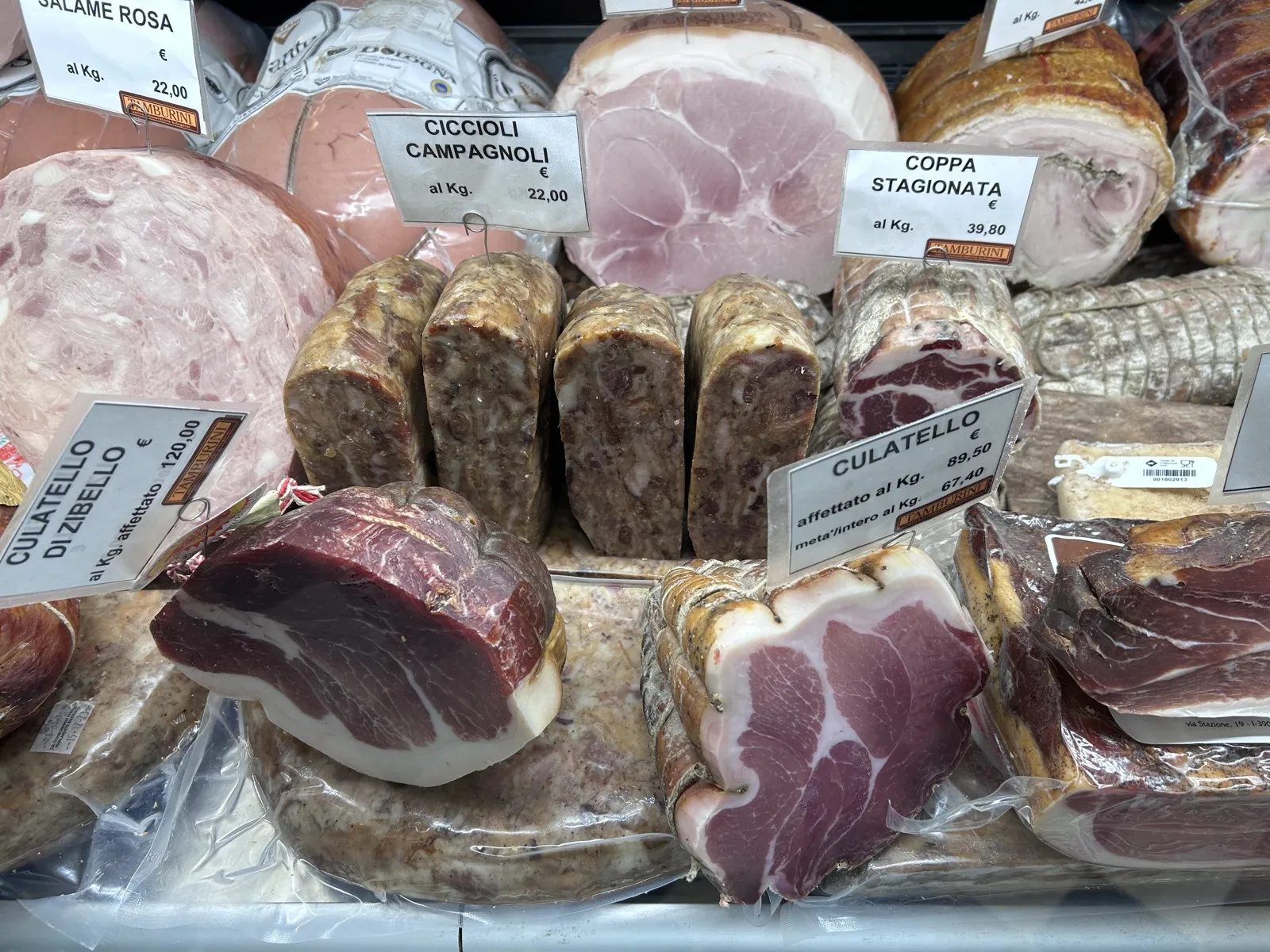 Slices of ciccioli, coppa and traditional cured meats displayed on a counter